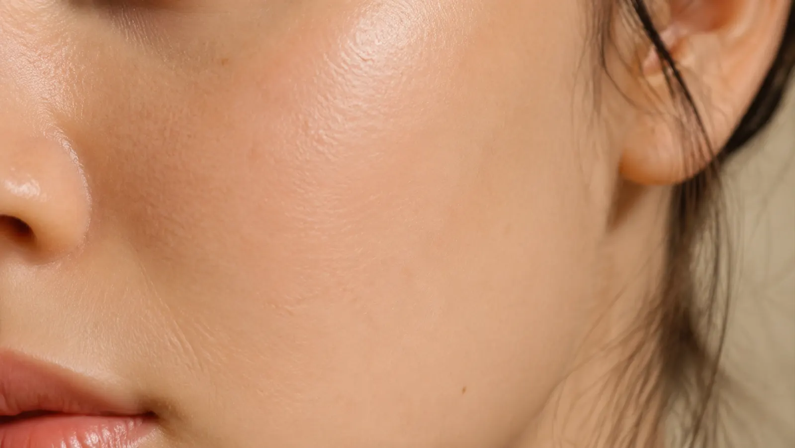 Close-up of calm, hydrated skin with no redness, gentle texture visible in soft light